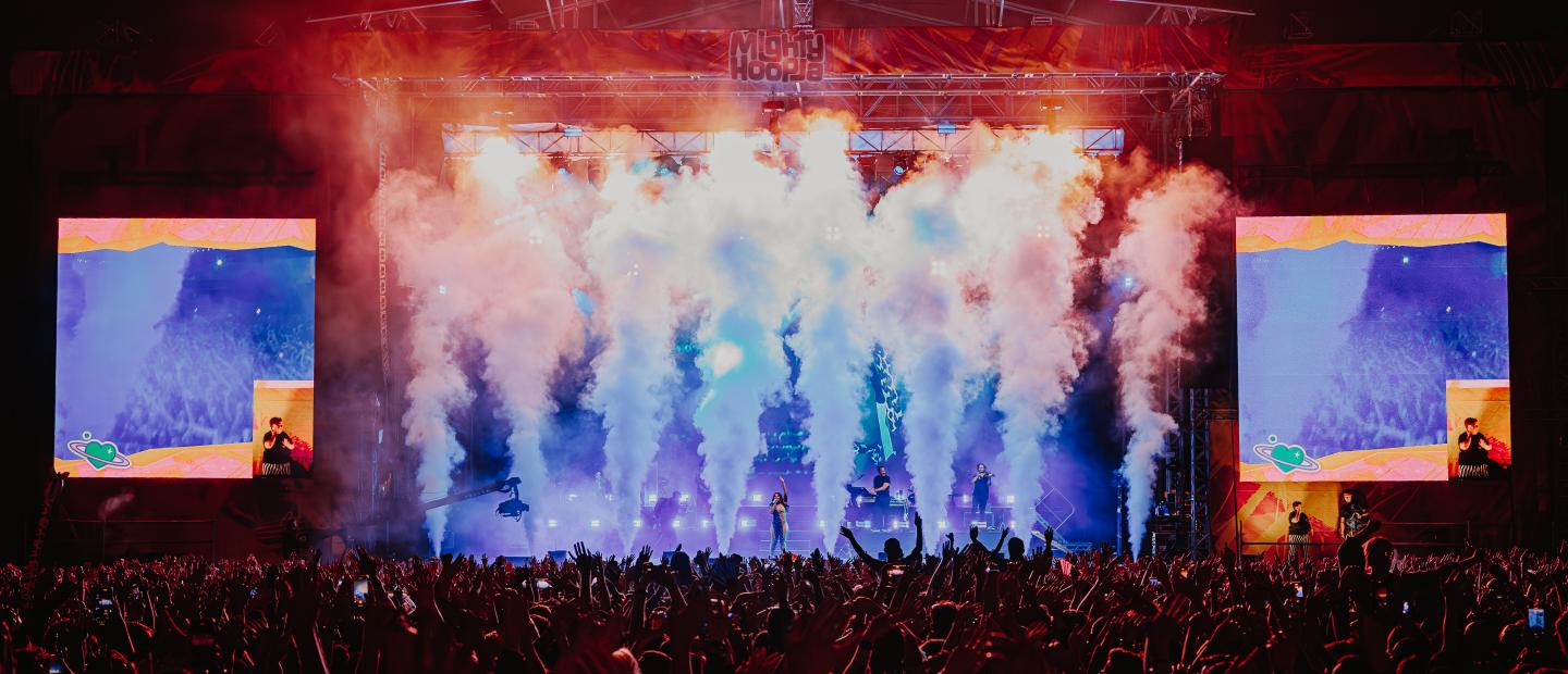 stage in darkness with smoke and screens