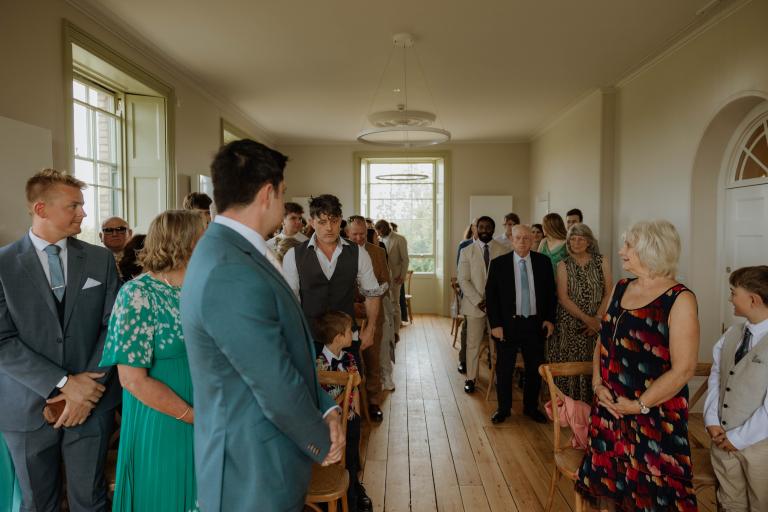 Wedding guests waiting for bride to walk down aisle