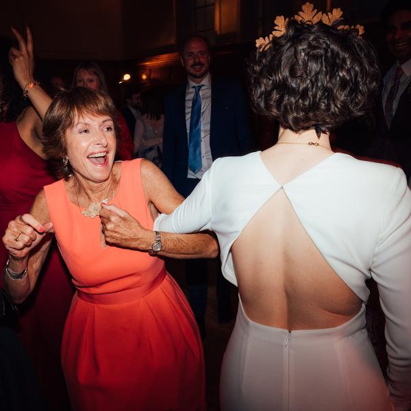 wedding guests and bride dancing at wedding